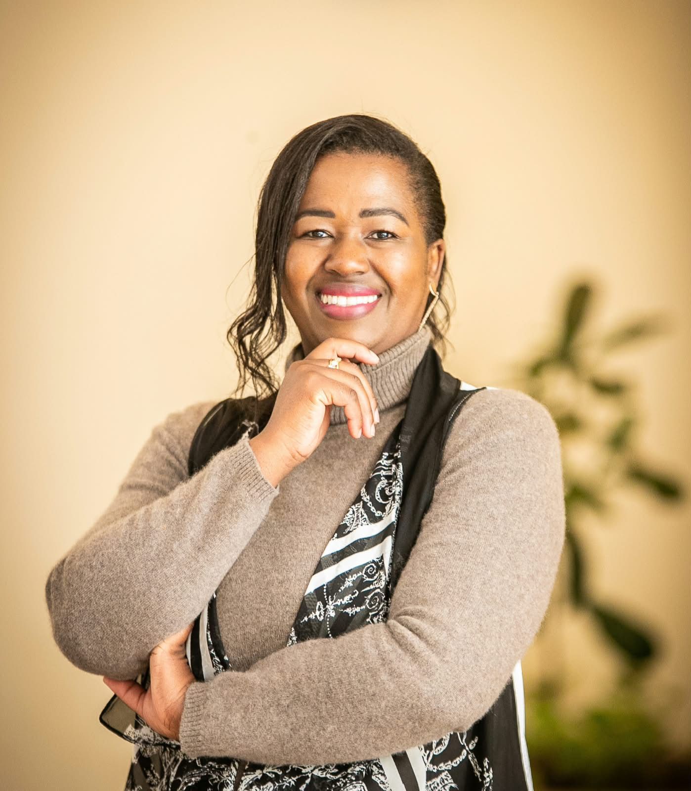 Professional African businesswoman in elegant attire, confident posture, warm studio lighting, executive presence, leadership embodied